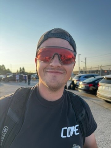Chris Cousall smiling outdoors in sunglasses.