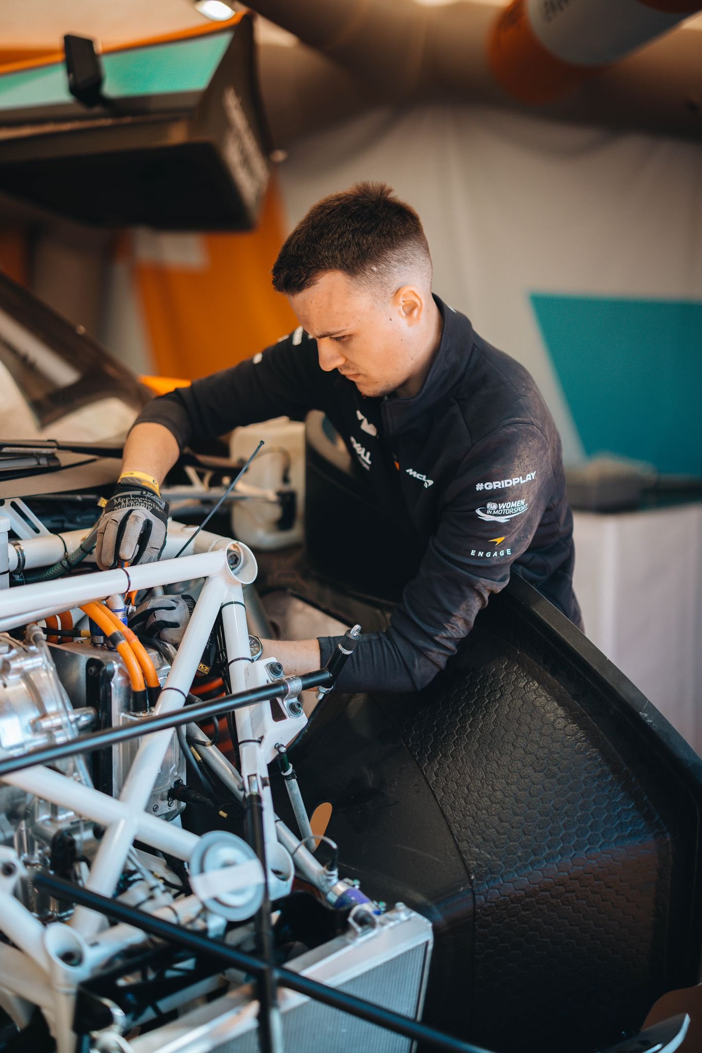 Chris Cousall working on a race car in the garage.