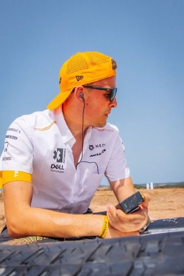Chris Cousall in team kit looking out across a race setting.