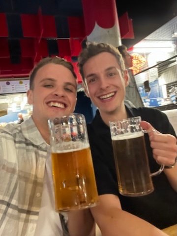 Chris Cousall sharing a beer with a friend on a night out.